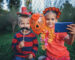 Day of the Dead and Halloween. Cute kids wearing in themed costumes for fun party. Girl with orange flowers in her hair and boy with moustache in crafted Mexican sombrero, autumn lifestyle